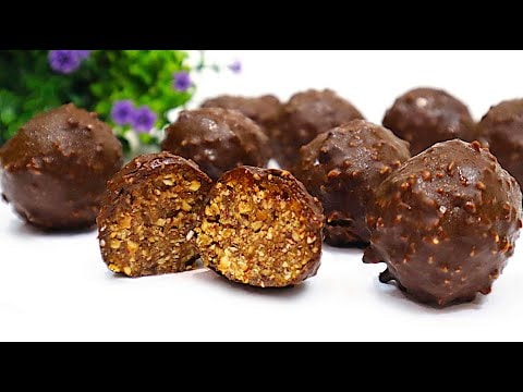 Almond Date Truffles with Dark Chocolate Peanut Coating — Homemade candies of toasted almonds, dates, raisins and honey, coated in melted 